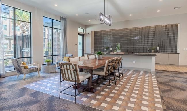 a common area dining room with large windows