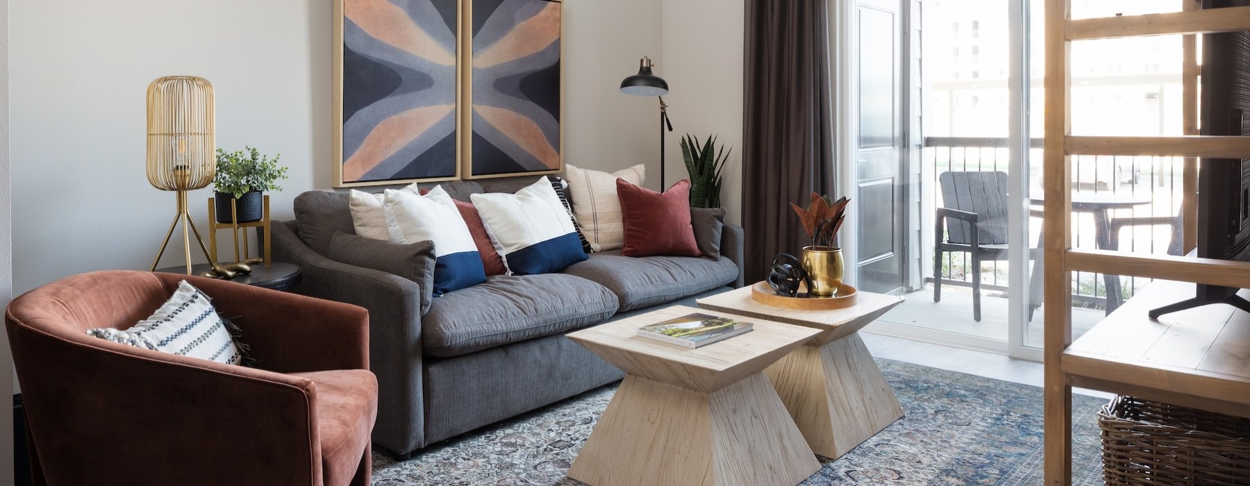 a living room with a large window a couch and a coffeetable