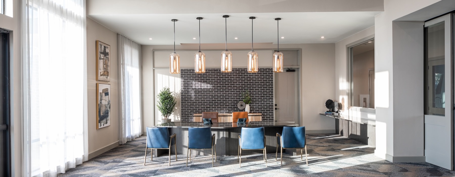 a dining room with a chandelier and a table with chairs