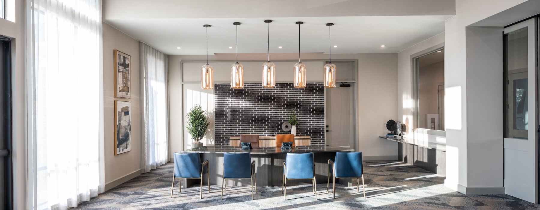 a dining room with a chandelier and a table with chairs