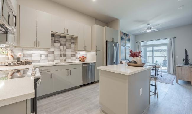 a kitchen with white cabinets and a kitchen island