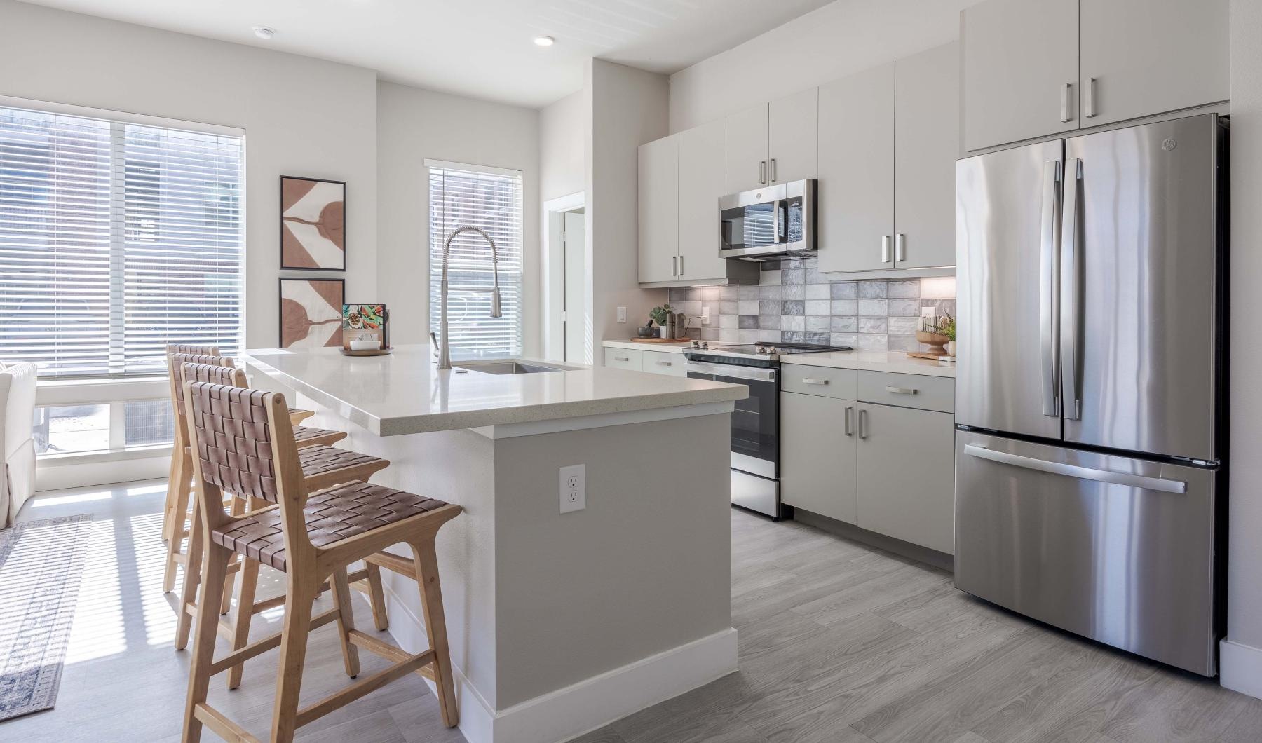 a kitchen with light cabinets and a kitchen island